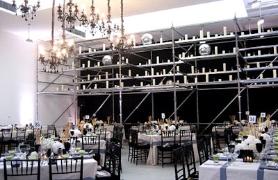 In the rear smoke-gray room, a towering scaffold supported white candles and silver balls. All rooms featured highline track graphics on the floor.