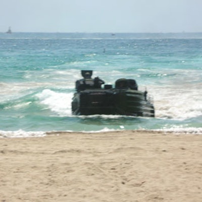 Amphibious assault vehicles maneuvered their waythrough both water and land during a midday showcase that saw militarypersonnel jump out of the tanks and take their firing positions on the ground.
