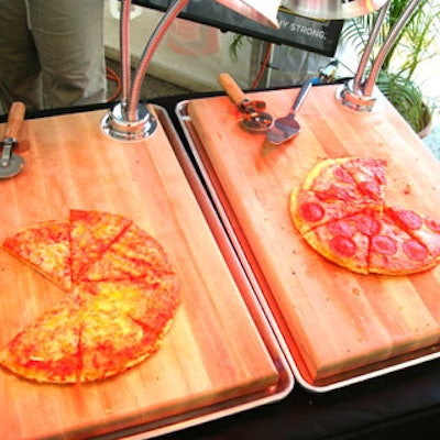 Pizzas were being sliced and served from atopblack U.S. Army tablecloths.