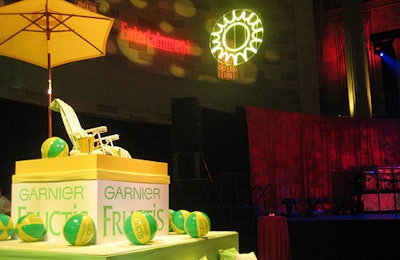 Garnier's display, in the brand's signature hues of lemon and lime,included a seating area topped with a lifeguard chair, where abikini-clad model sat for the duration of the event. A neon sun hovering over guests helped unify the multiple branded areas in the space.