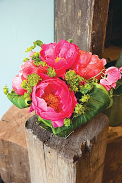 Crary contrasts coral peonies and pink sweet peas with vibrant greenery.