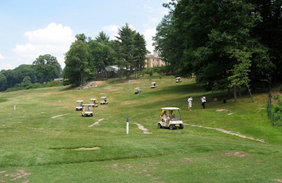 A fleet of golf carts met guests in the field where they landed.