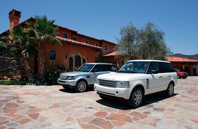 Vehicles stood sentry in front of the manse.