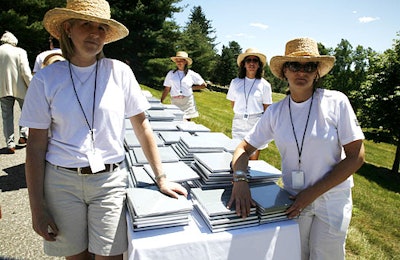 Volunteers in straw hats and matching white T-shirts handed out limited-edition commemorative books.