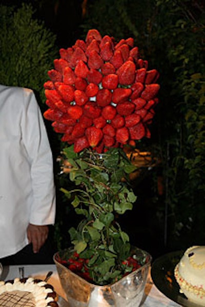 The dessert displays, including elaborate presentations of strawberries and profiteroles, were hidden in a magical forest.