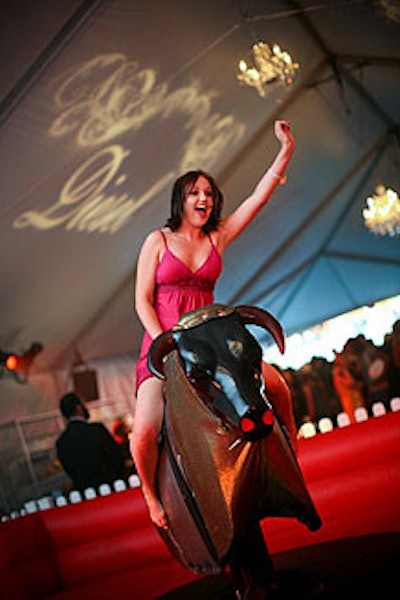 A mechanical bull station surrounded by white fencing sat in the middle of the tent, making guests who rode the bull the center of attention.