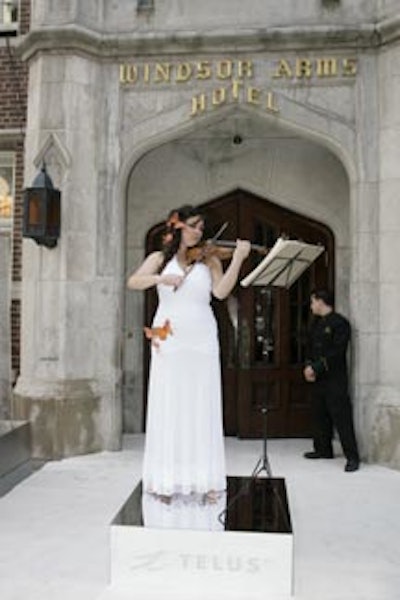 An orange butterfly adorned the dress worn by a conservatory student, who played the violin at the venue entrance.