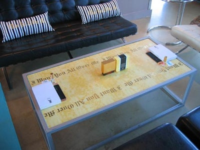 The L.A.M.B. tagline 'I want you all over me' appeared in dark gold lettering on light gold coloured prints covering metal-frame coffee tables.