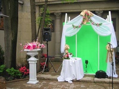 Signature Studios snapped photos of guests in a “Vegas” wedding chapel with flowery decor and a green-screen backdrop.