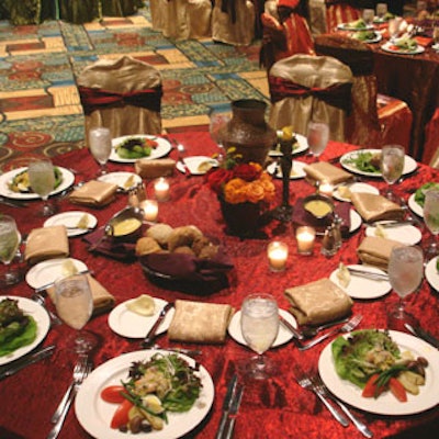 The tables in the grand hall featured different combinations of red, gold, orange, and green linens, as well as a variety of elements of unique centerpieces.