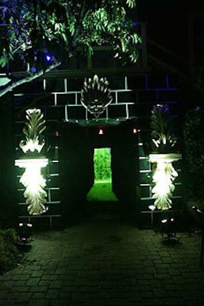 Guests passed under an oversize black granite fireplace, proceeded through a dark tunnel, and then walked through a green-flamed fog screen to enter the interior space.