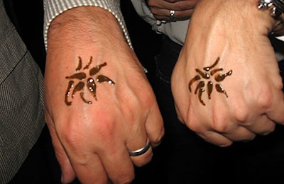 Henna tattoo artists appllied tattoos in the form of the Navan logo, an orchid blossom.