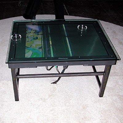 Keith Largent built tables with plasma screens (rented from Scharff Weisberg) that showed the Sama logo during the party.
