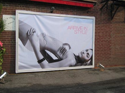 A poster from 3 Design of a woman dressed provocatively in hot pants and a skimpy top underscored the event’s “arrive in style” theme.