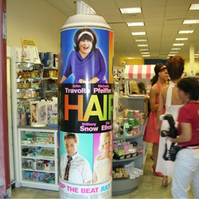 A 10-foot-tall hair spray bottle flanked by an oversize Hairspray movie poster adorned the entrance.