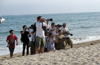 Paparazzi took advantage of the public beachfront and staked their claims, and helicopters flew overhead; Lindsay Lohan, Tara Reid, and Taye Diggs were among the guests.