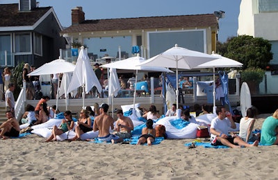 The beach in front of the Polaroid house was crowded with partygoers on blue Boost Mobile towels.