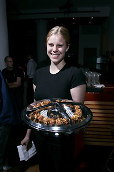 Guests grabbed food such as eggplant meatballs off hubcap serving trays.