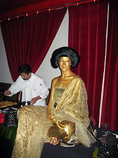A gold-painted living Buddha accented Mie N Yu's Silk Road Celebration tasting event.