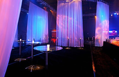 The after-party was a mostly black space; sheer white linens hung throughout.