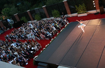 Guests watched the performance from their seats on the carpeted tennis court.