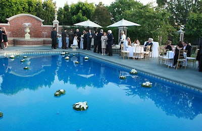 Anchored floating flowers decorated the pool, around which guests sipped pre-dinner cocktails.