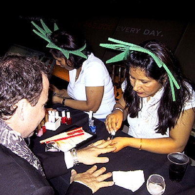 Manicurists from Nails For Venus painted glittering designs on guests' nails inside the Hall of Biodiversity.