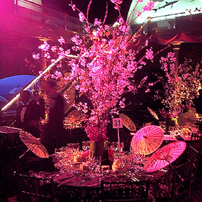 Meredith Perez of Belle Fleur placed cherry blossom, dendrobium orchids and wheatgrass centerpieces on top of Chinese brocade tablecloths for the American Museum of Natural History's Wonders of the Far East Winter Dance.