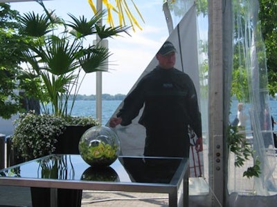 McNabb Roick decorated the black, white, and lime green affair with tons of greenery and decorative sails with images of the sailing team around the tent.