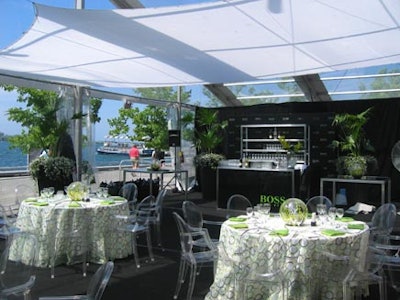 The tent design included custom linens by McNabb Roick in green and white with textured rings, clear Louis Ghost chairs, black carpet and furniture, and green enhancements everywhere.