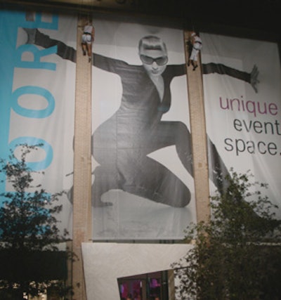The Moore Building could be seen from blocks away, with bright spotlights illuminating the venue while two people rappelled down the side of the building to draw people's attention to the large poster displayed there.