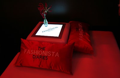Customized pillows were strewn across white sofas and chairs.