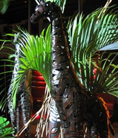 Custome metal giraffe figures were enhanced by lush tropical foliage on buffet tables in the dining room.