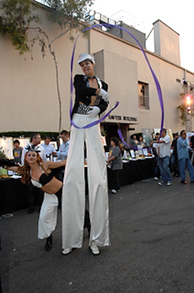 Eye of Newt troupe members circulated the Lot on stilts.