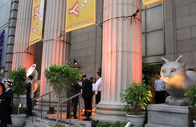 Banners and uplit cat sculptures adorn the facade of the Acatemy.