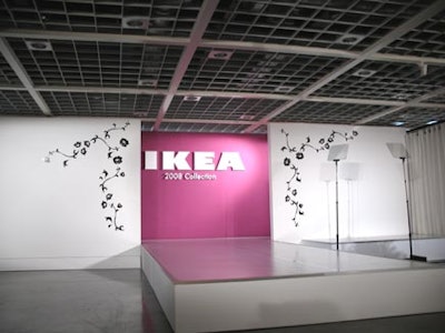 The runway featured a pink backdrop with white walls decorated with black floral accents similar to the design used for the invitation.