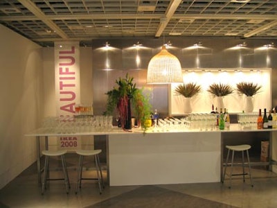 IKEA accessories enhanced the white bar, which featured a stainless steel backdrop, white stools, and signage with the word beautiful, the theme of the catalogue and the event.