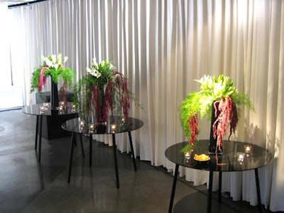 Votive candles surrounded cascading floral arrangements.