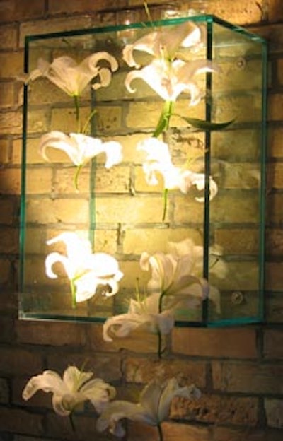 White lilies were strung along the outside of clear acrylic boxes on the brick walls of the venue.