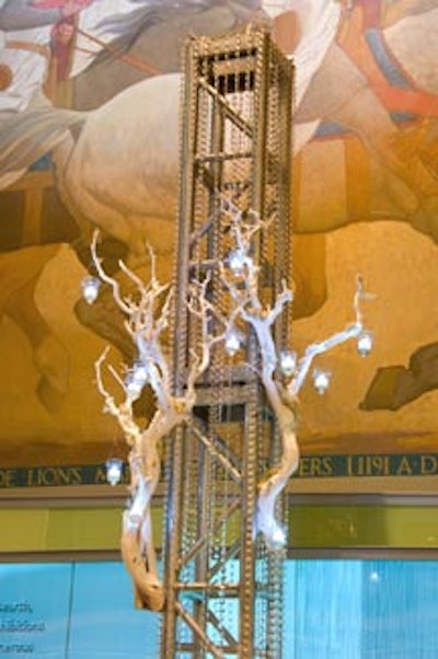 Designing Trendz spiffed up the dining area with tall light truss pillars adorned by strands of crystals and barren branches strung with tea lights.