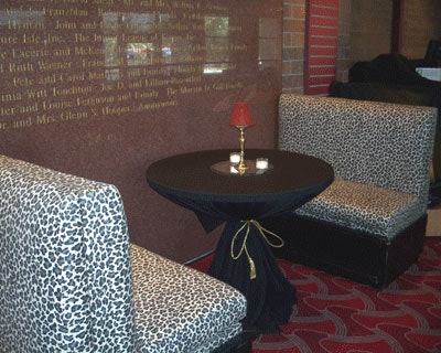 Leopard-print booths placed opposite black linen-covered cocktail rounds provided intimate seating areas in the V.I.P. lounge.
