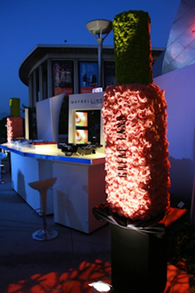 Giant mascara bottles made from flowers flanked Maybelline's lounge area.