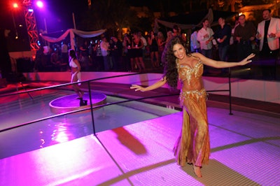 A belly dancer performed at the neon-hued Maxim Oasis fete.