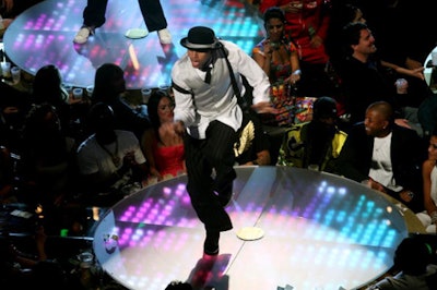 Singer Chris Brown jumped from one glowing podium to another during his VMA performance, and received a pat on the back from audience member Diddy when he finished.