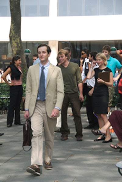 At Bryant Park, models handpicked from the crowd walked between green tables, showcasing whatever hat or suit jacket was given to them.