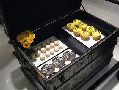 Cupcakes and cookies, decorated with the phrase 'Eat Me,' alluded to food found in the classic