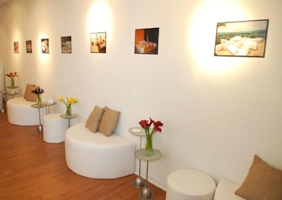 Guests entered through a white lounge decorated with flower arrangements provided by Eggwhites.