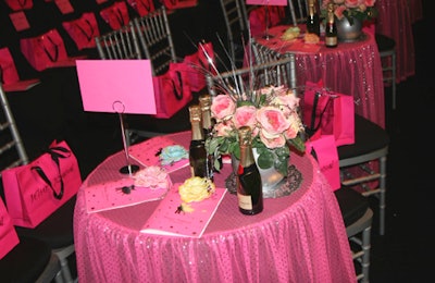 Alongside the runway, front-row guests at pink-cloth-covered tables sipped champagne from mini bottles.