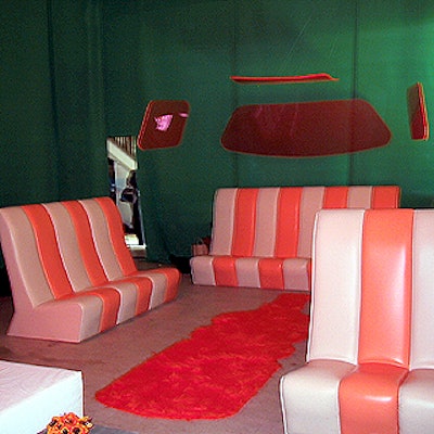 Orange and white striped seating (custom-made by EventQuest) was arranged to look like the back of a limousine, with pieces of Lucite suspended from the ceiling to suggest windows.