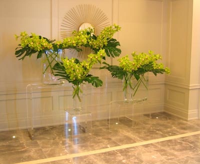 Furnishings by Corey and Exclusive Affair Rentals teamed up to create floral arrangements resting on clear acrylic bases.
